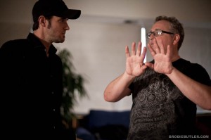 Director of photography Guy Livneh talks to Director A.J. Carter on set on "23"